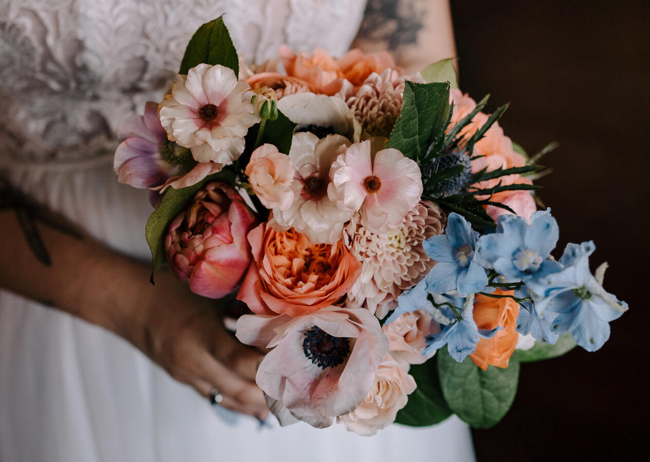 A close up of a woman holding a bridal bouquet.